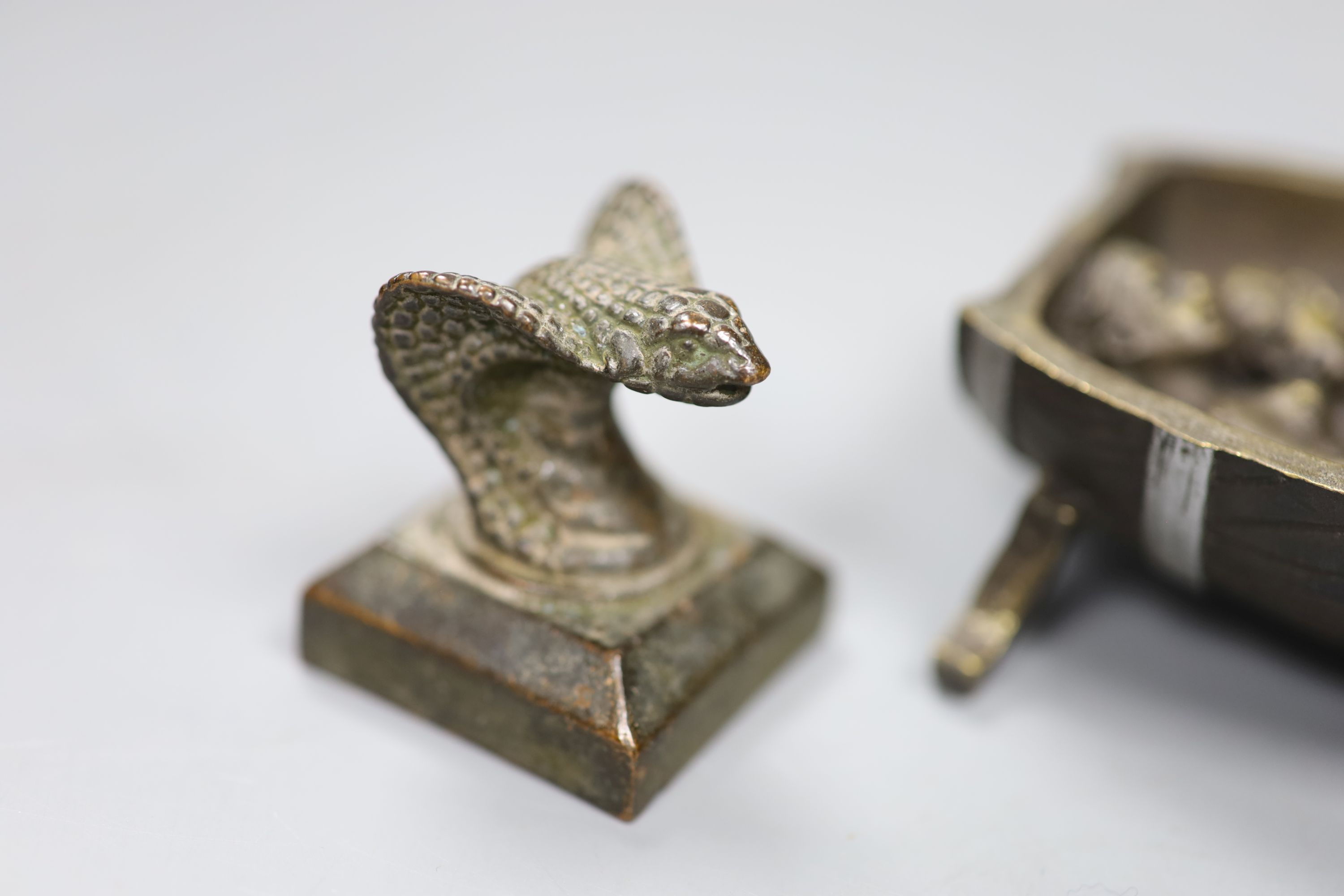 Two novelty bronze seals and novelty bronze cherub group, height 9cm